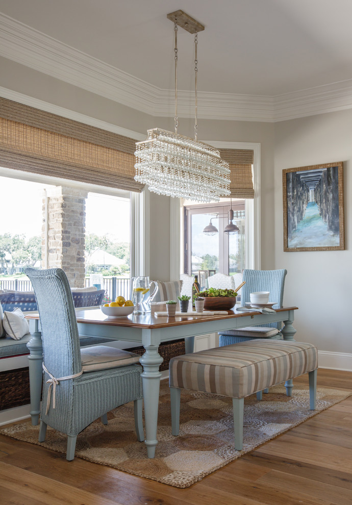 Beach style medium tone wood floor and brown floor dining room photo in Jacksonville with gray walls