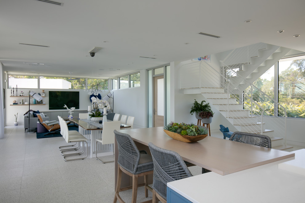 Inspiration for a medium sized coastal open plan dining room in Tampa with white walls, concrete flooring, no fireplace and multi-coloured floors.