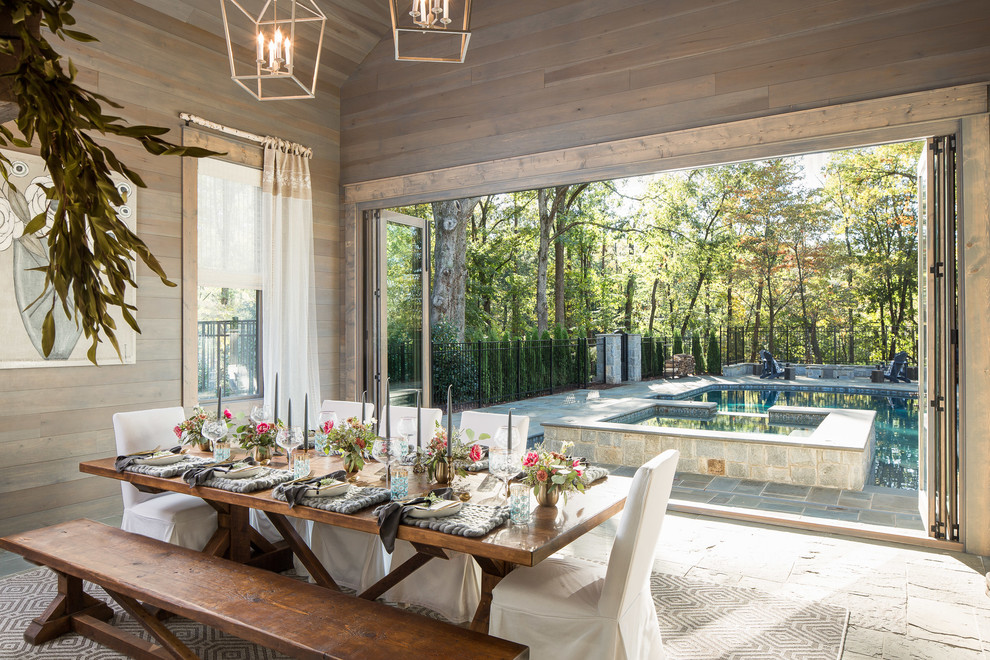 Example of a large country slate floor dining room design in Atlanta with brown walls