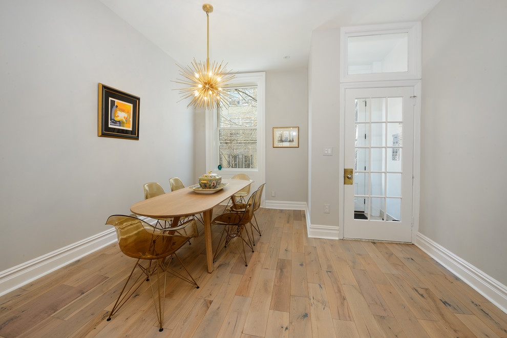 Inspiration for a contemporary light wood floor and beige floor great room remodel in New York with gray walls