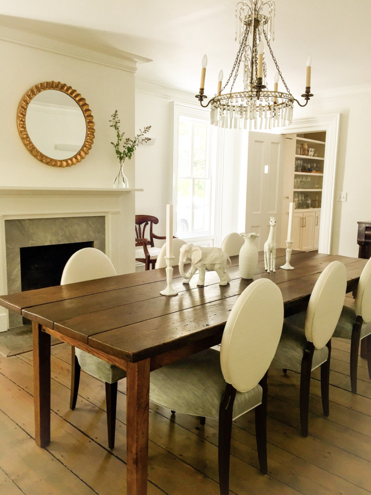 Photo of a large classic enclosed dining room in New York with white walls, dark hardwood flooring, a standard fireplace and a wooden fireplace surround.