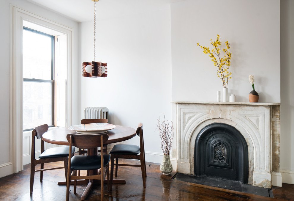 Transitional dark wood floor dining room photo in New York with white walls