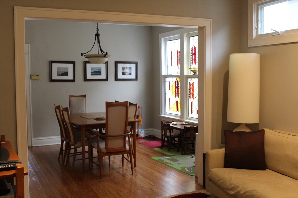 This is an example of a medium sized classic dining room in Chicago with grey walls, light hardwood flooring and no fireplace.