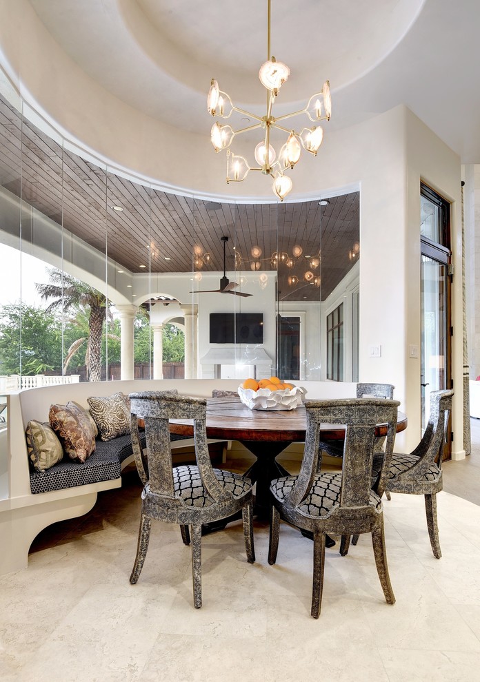 Expansive mediterranean open plan dining room in Austin with beige walls, no fireplace and beige floors.