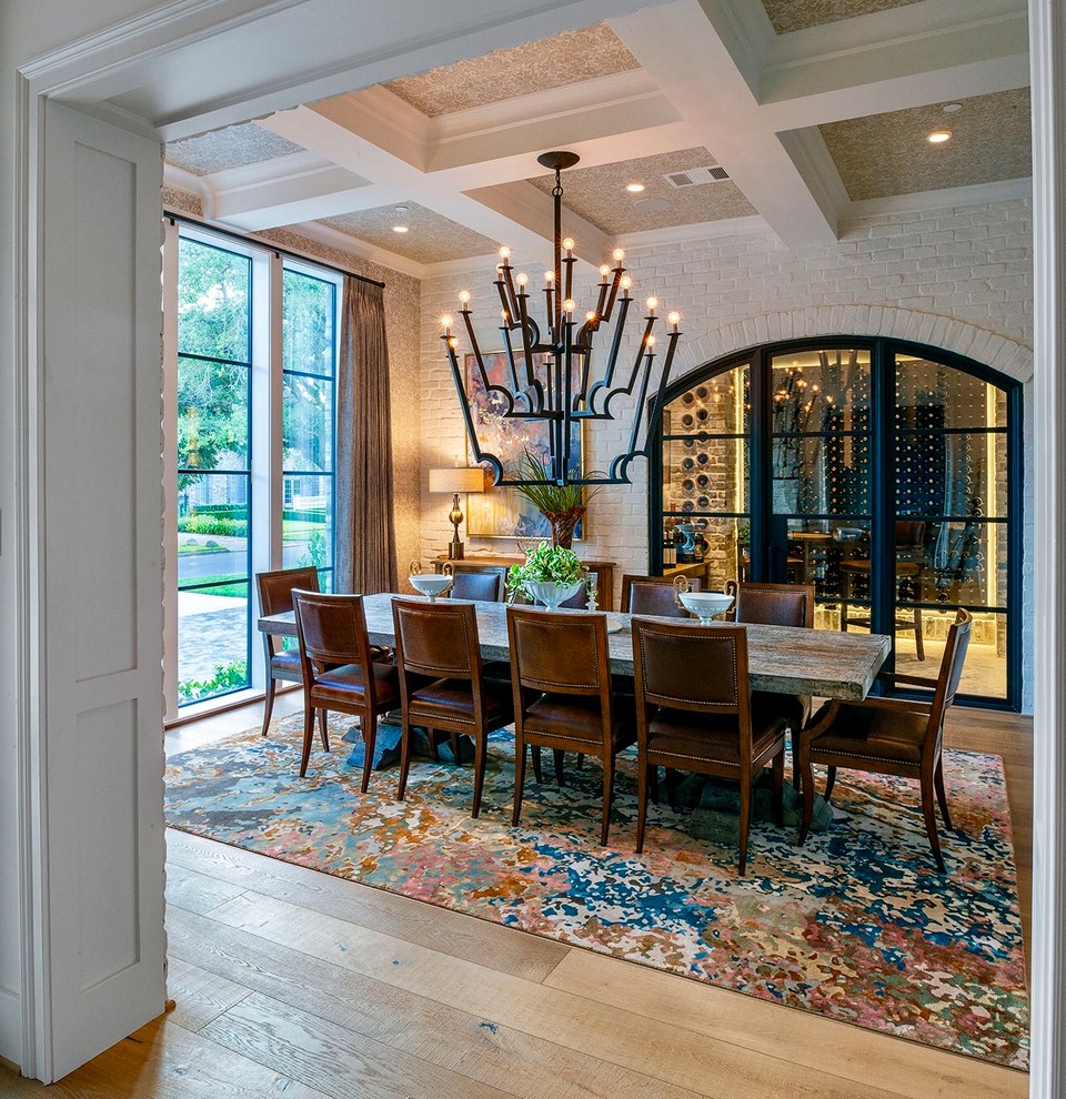 Large traditional enclosed dining room in Houston with beige walls, light hardwood flooring, beige floors and feature lighting.