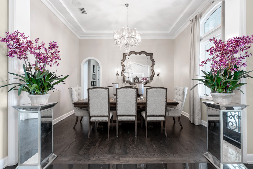 Example of a large classic dark wood floor and brown floor enclosed dining room design in Tampa with beige walls