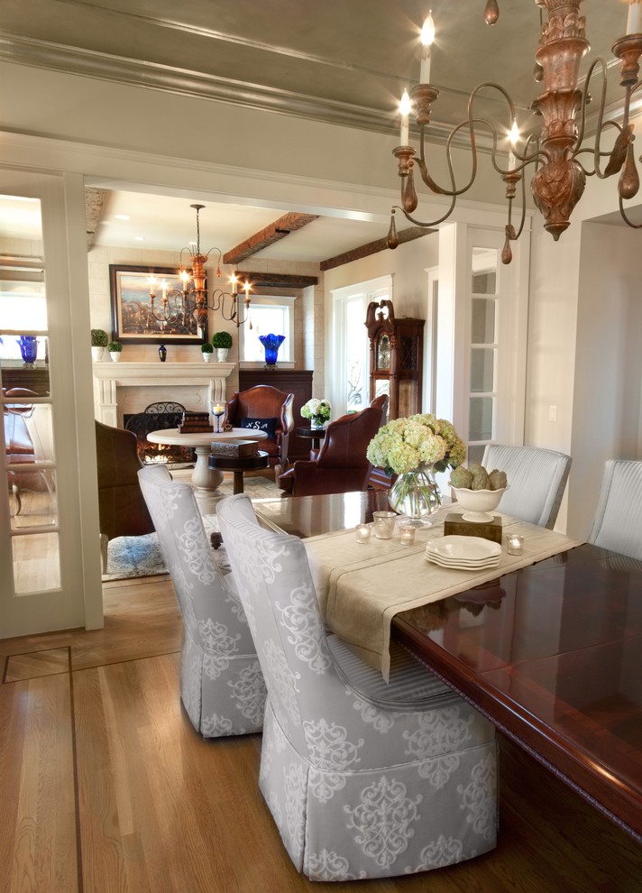 Dining room - large traditional light wood floor dining room idea in San Francisco with beige walls, a standard fireplace and a stone fireplace