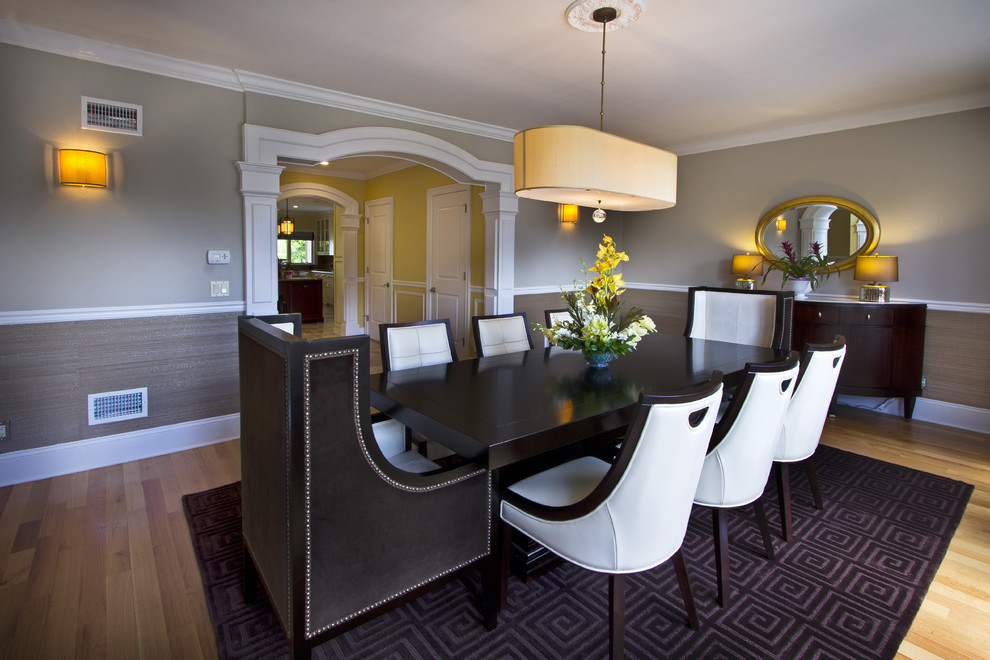 Example of a trendy medium tone wood floor dining room design in New York with gray walls