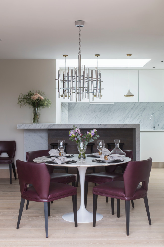 Design ideas for a contemporary kitchen/dining room in London with light hardwood flooring.