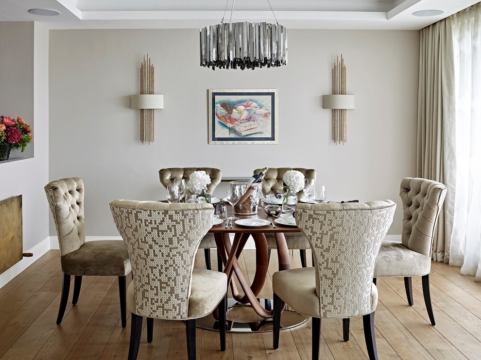 Inspiration for a contemporary dining room in London with beige walls, light hardwood flooring and beige floors.