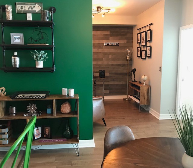 This is an example of a small urban dining room in Ottawa with grey walls and medium hardwood flooring.