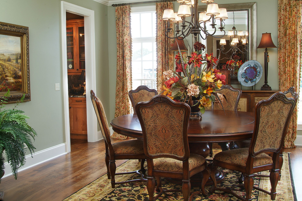 Medium sized classic enclosed dining room in Nashville with green walls, dark hardwood flooring and no fireplace.