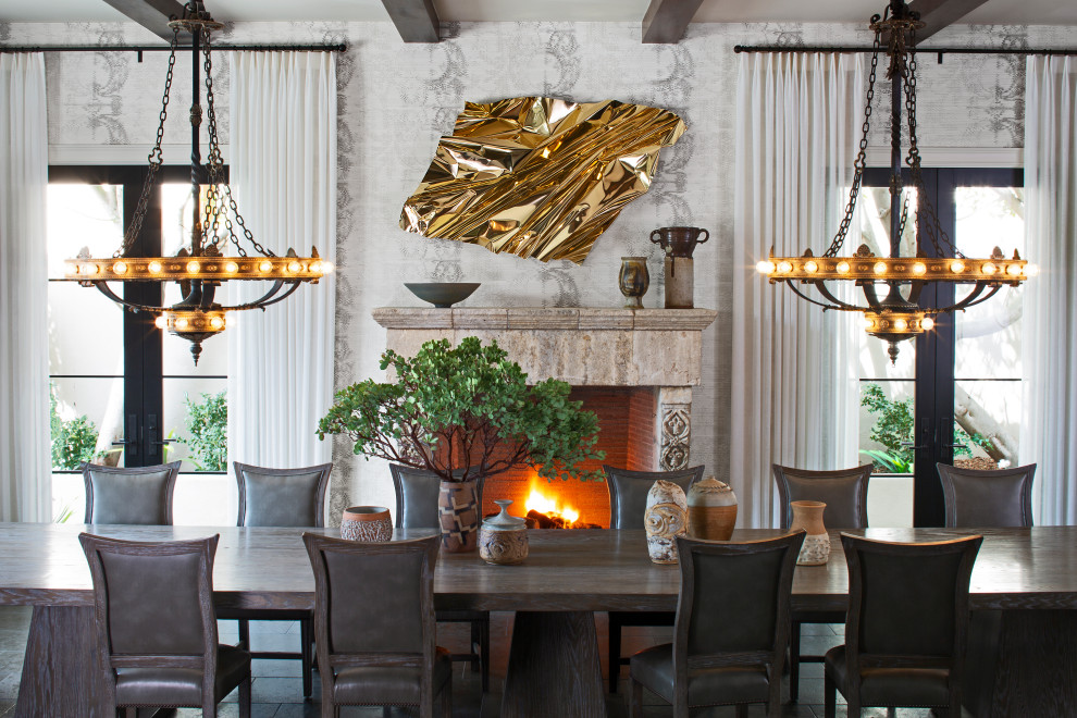 Inspiration for a mediterranean wallpaper dining room remodel in Los Angeles with multicolored walls, a standard fireplace and a stone fireplace