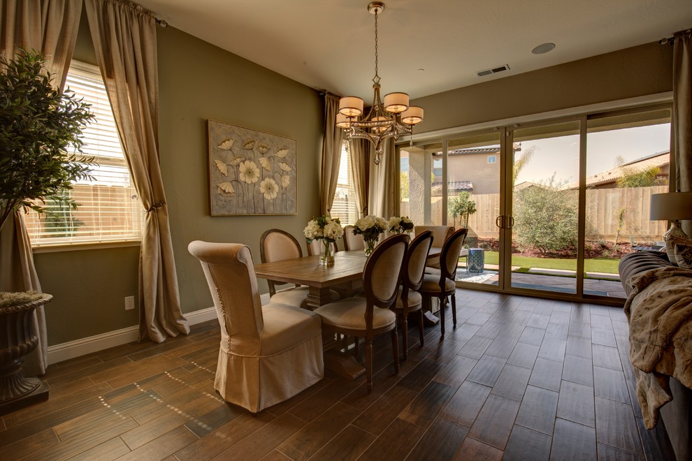 Farmhouse open plan dining room in Sacramento with green walls.