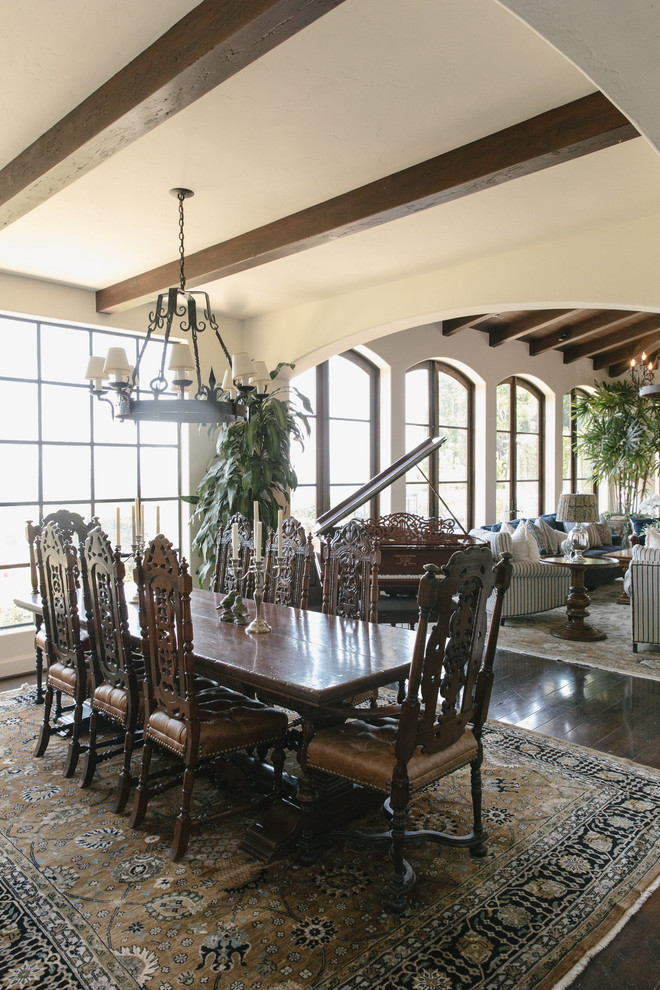This is an example of a large mediterranean open plan dining room in Los Angeles with beige walls, dark hardwood flooring and brown floors.