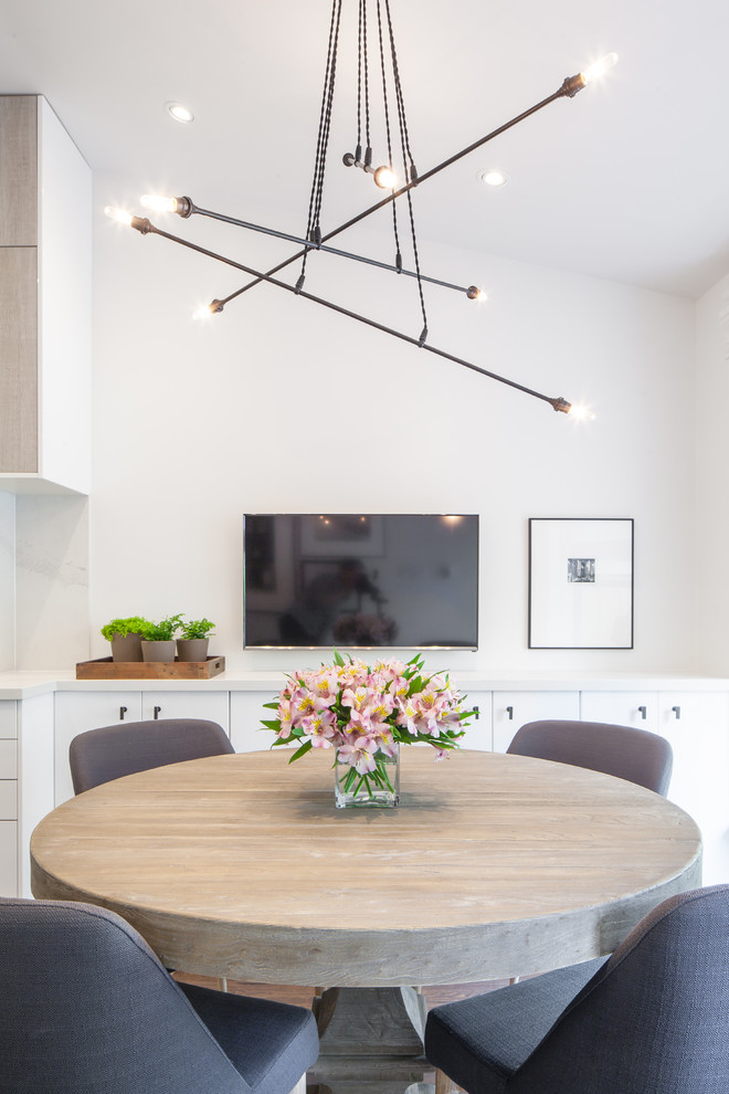 Kleine Moderne Wohnküche ohne Kamin mit braunem Holzboden und beiger Wandfarbe in Toronto
