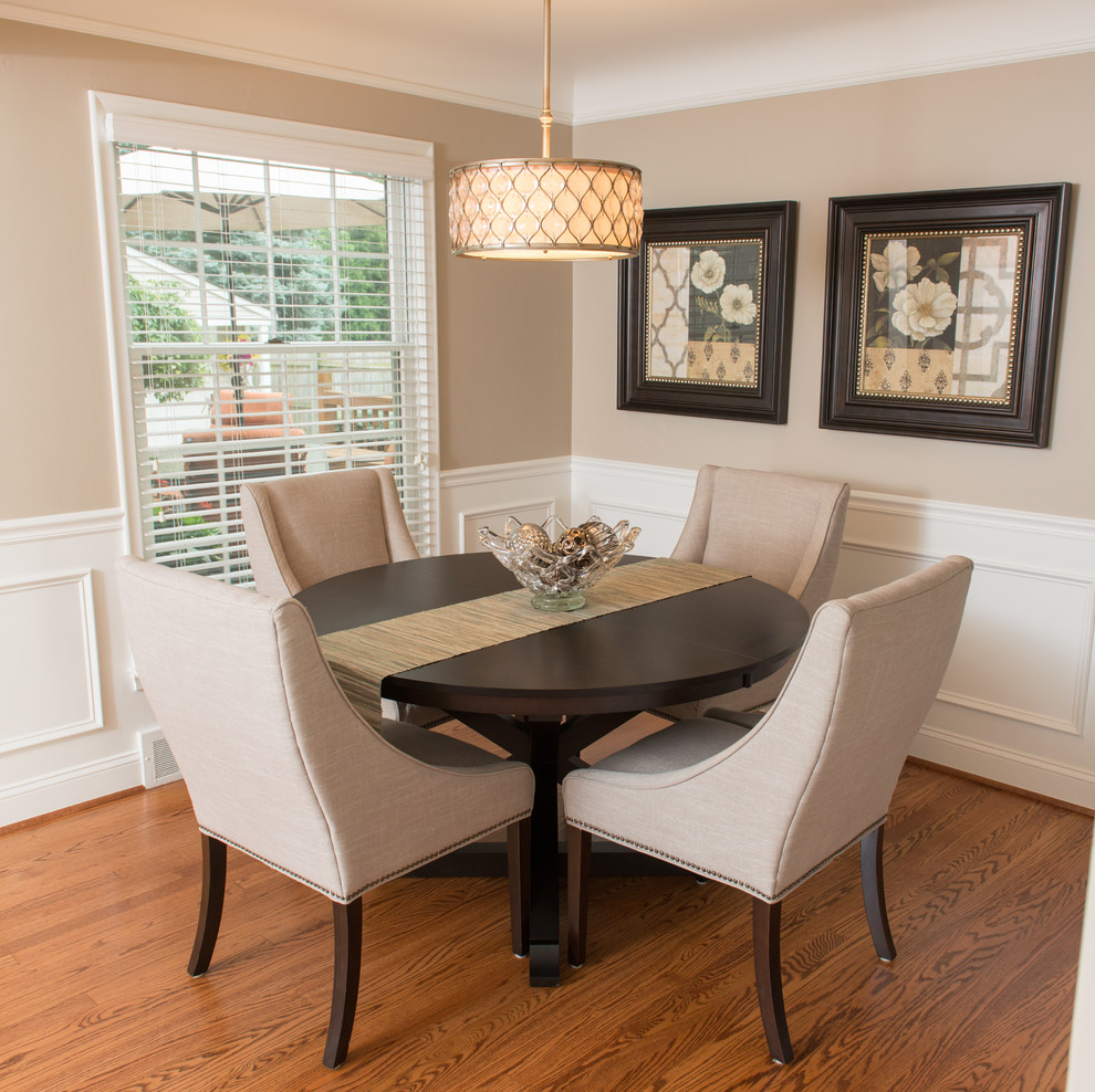 Example of a mid-sized trendy medium tone wood floor dining room design in Detroit with beige walls