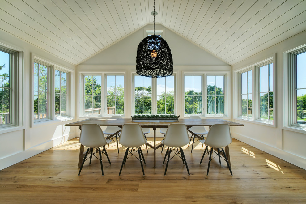 Inspiration for a large nautical dining room in Boston with white walls, medium hardwood flooring and brown floors.