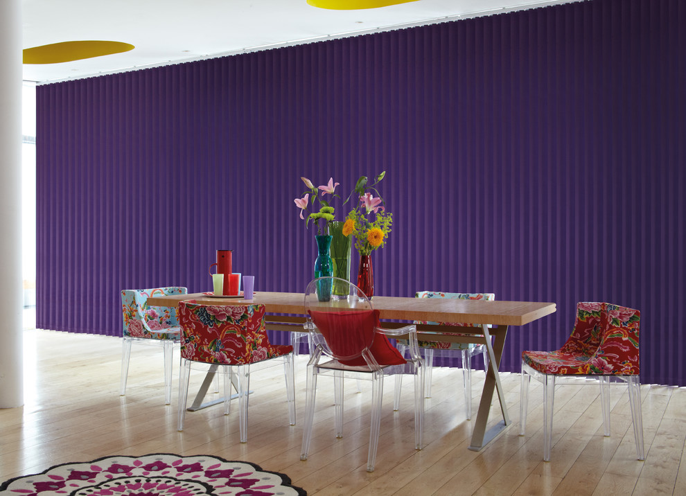 Ispirazione per una sala da pranzo aperta verso la cucina design di medie dimensioni con pareti viola, pavimento in compensato e pavimento marrone