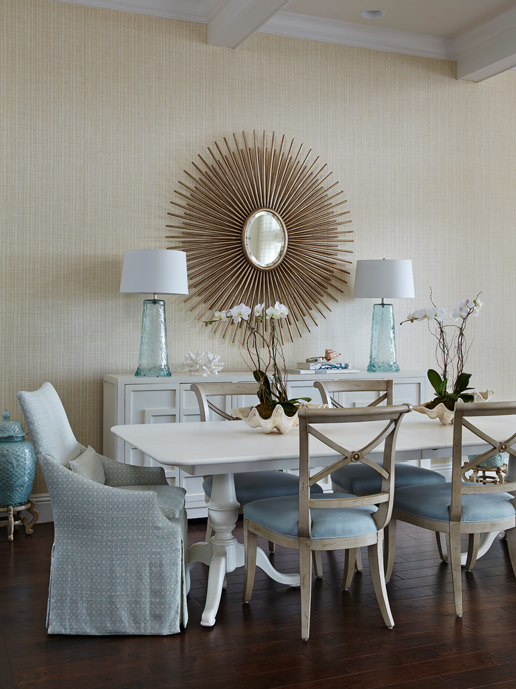 Inspiration for a coastal dining room in Miami with beige walls and feature lighting.