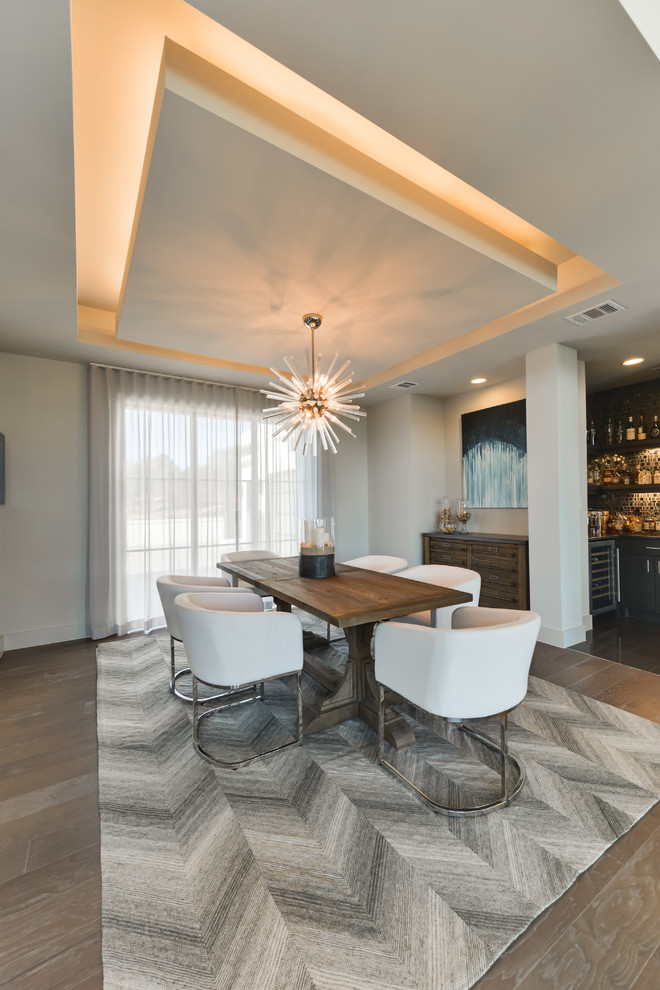 Photo of a contemporary dining room in Austin with grey walls, medium hardwood flooring and brown floors.