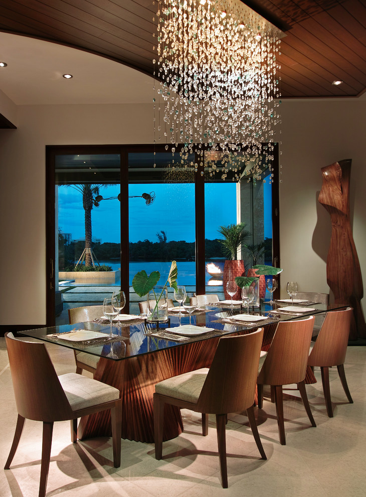 Inspiration for a world-inspired dining room in Miami with beige walls.