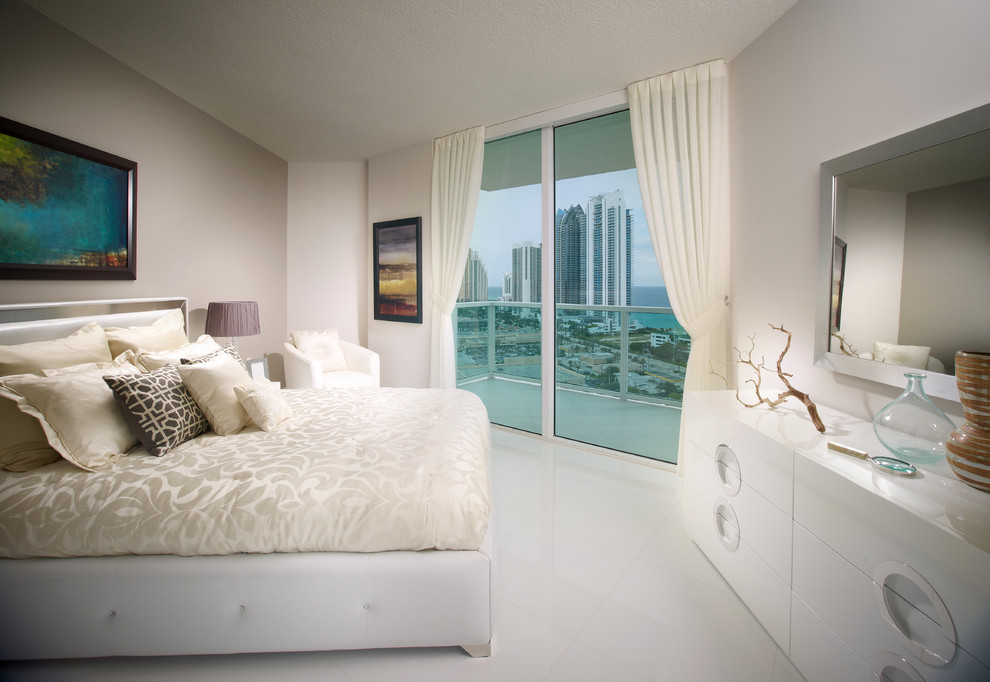 Example of a mid-sized trendy ceramic tile bedroom design in Miami with white walls and no fireplace