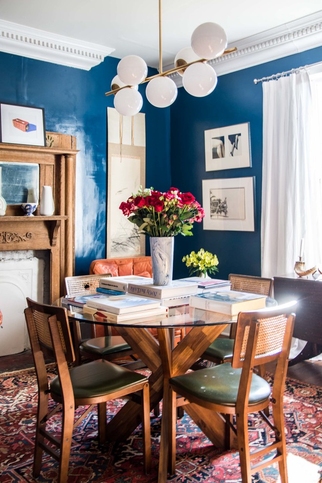 Example of a mid-sized eclectic kitchen/dining room combo design in Atlanta with blue walls, a standard fireplace and a wood fireplace surround