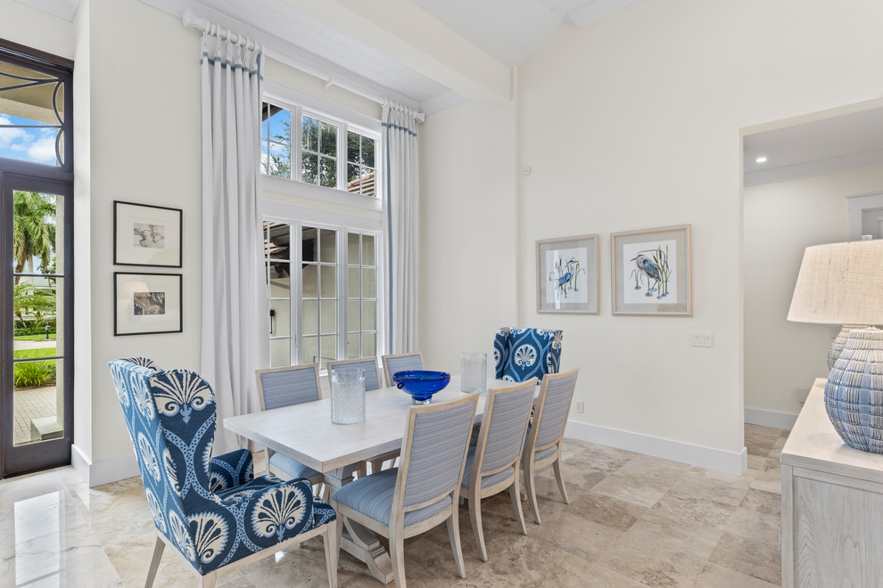 Design ideas for a coastal open plan dining room in Miami with white walls, no fireplace and beige floors.