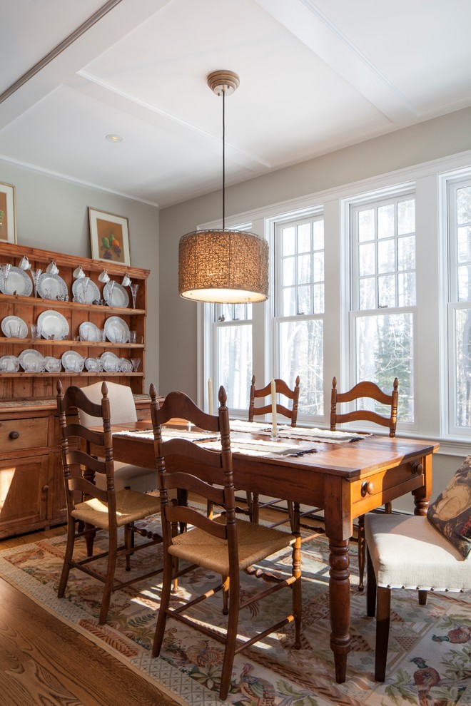 Medium sized country kitchen/dining room in Portland Maine with medium hardwood flooring and beige walls.