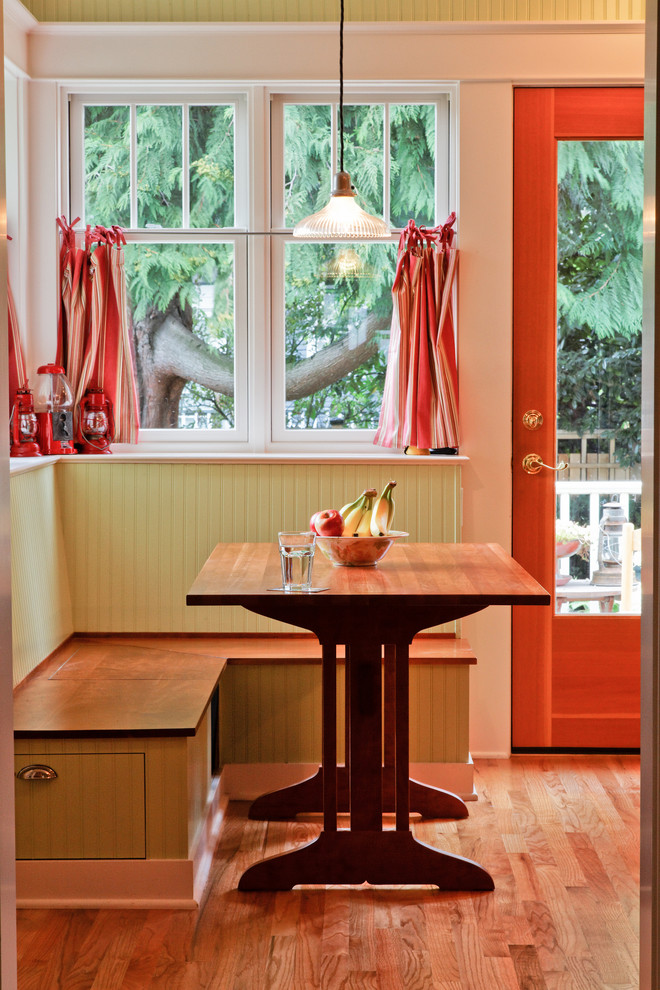 Example of a mid-sized arts and crafts light wood floor dining room design in Seattle