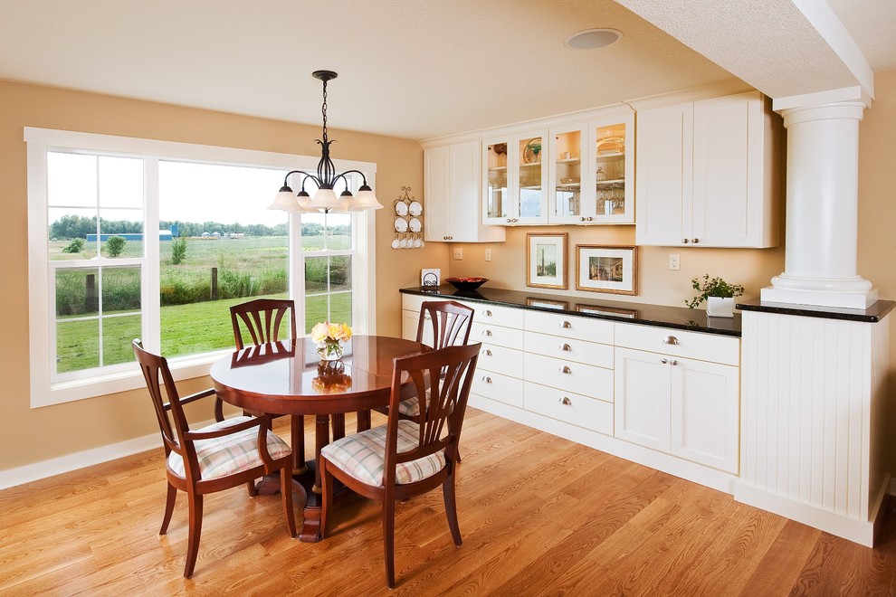 Traditional kitchen/dining room in Portland with yellow walls and medium hardwood flooring.