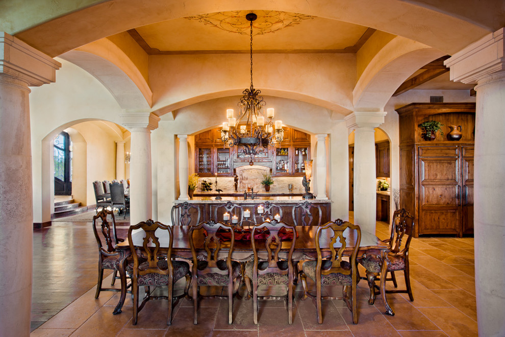This is an example of an expansive mediterranean kitchen/dining room in Austin with beige walls, travertine flooring and no fireplace.