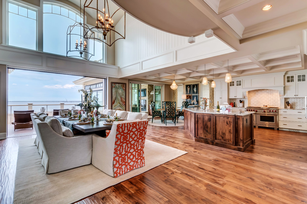 Example of a huge beach style medium tone wood floor great room design in Dallas