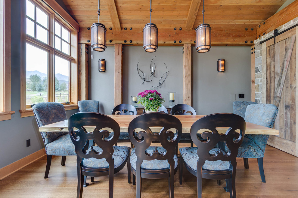 Design ideas for a medium sized retro dining room in Denver with blue walls and dark hardwood flooring.