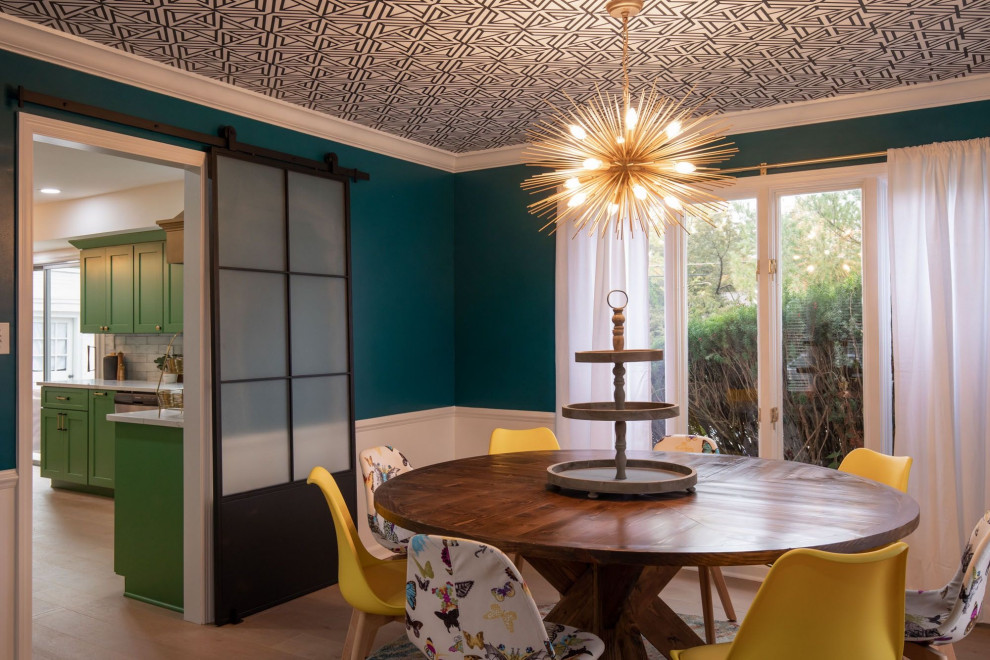 Inspiration for a medium sized traditional enclosed dining room in Indianapolis with green walls, light hardwood flooring, beige floors, a wallpapered ceiling and wainscoting.