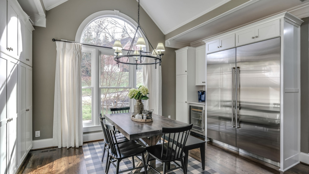 Kitchen/dining room combo - large transitional medium tone wood floor and brown floor kitchen/dining room combo idea in Nashville with gray walls
