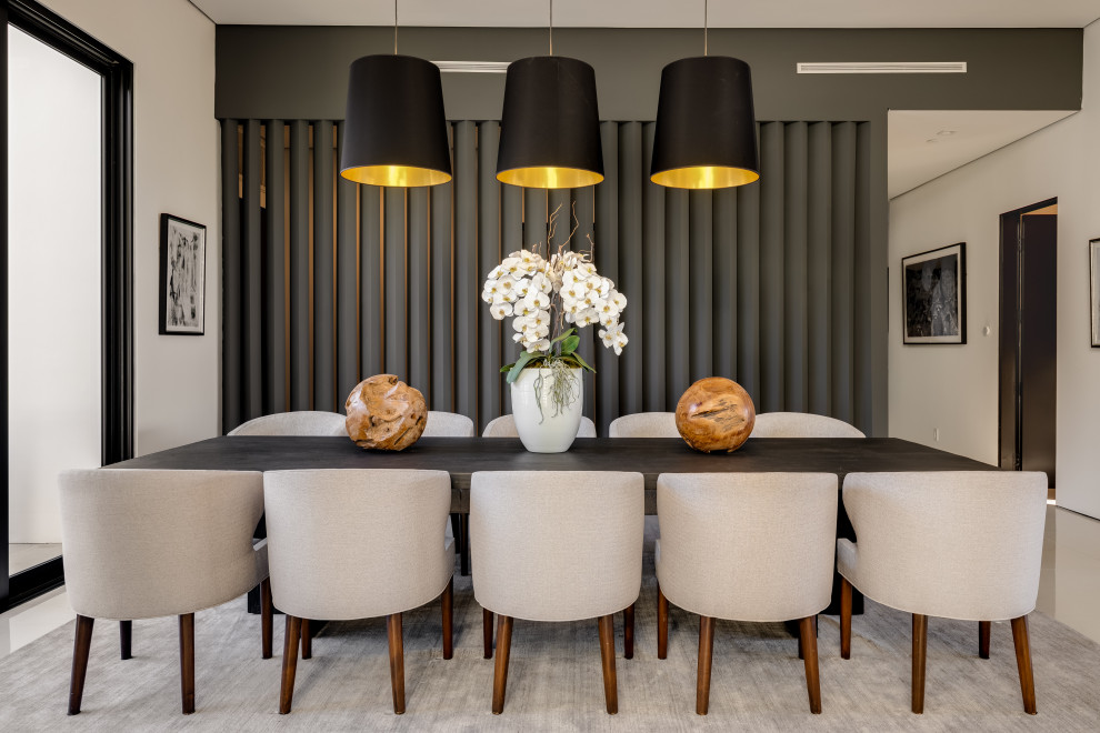 This is an example of a large contemporary open plan dining room in Los Angeles with grey walls, porcelain flooring, no fireplace and white floors.