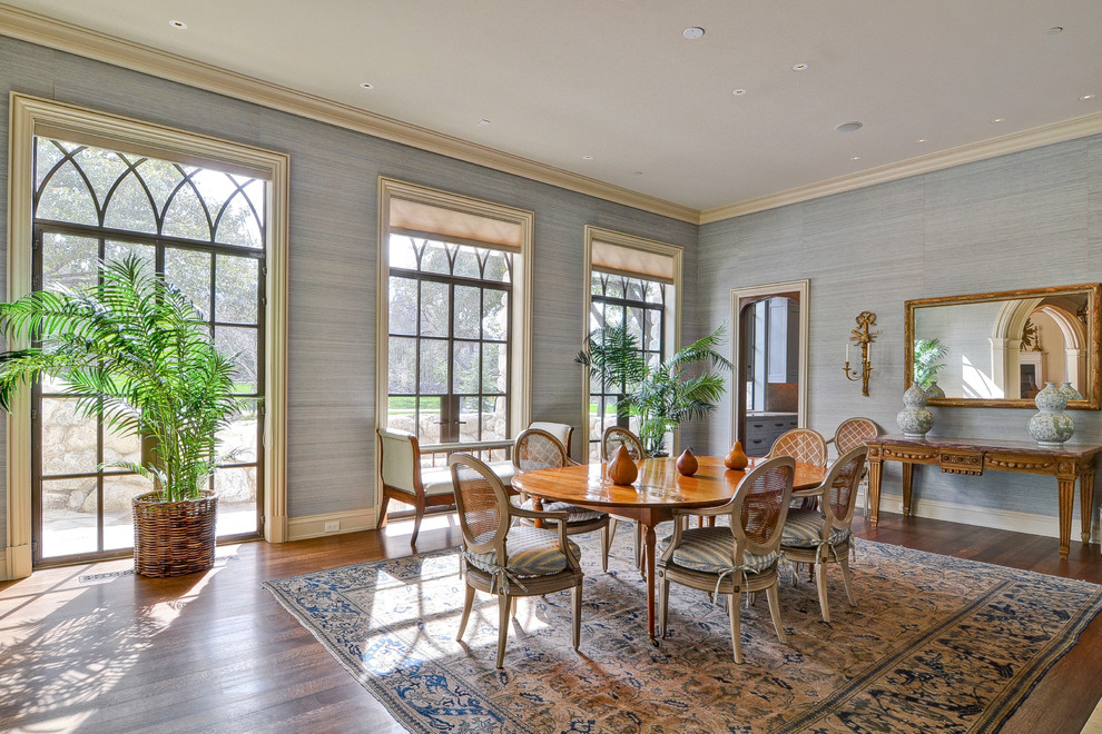 This is an example of a large classic enclosed dining room in Dallas with blue walls, medium hardwood flooring and brown floors.