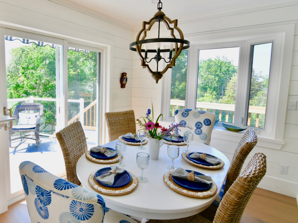 Small coastal dining room in Other with light hardwood flooring and beige floors.