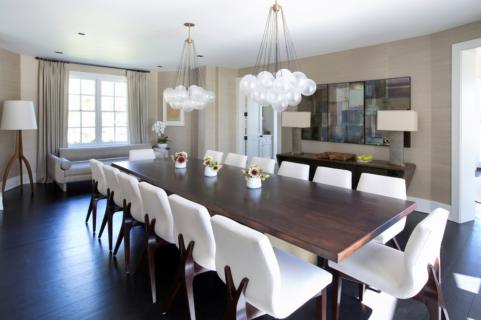 Traditional enclosed dining room in New York with beige walls, dark hardwood flooring and feature lighting.