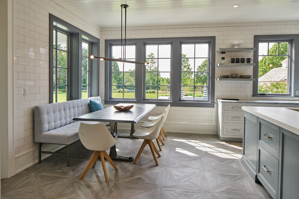 Inspiration for a mid-sized transitional gray floor and medium tone wood floor kitchen/dining room combo remodel in New York with white walls and no fireplace