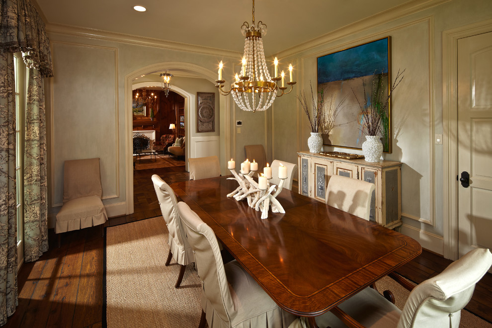 This is an example of a traditional enclosed dining room in Houston with beige walls and dark hardwood flooring.