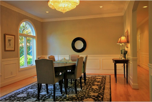 Diseño de comedor clásico con paredes beige y suelo de madera clara