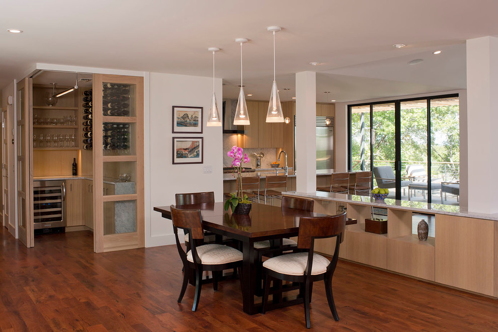 Idée de décoration pour une salle à manger ouverte sur le salon bohème de taille moyenne avec un mur blanc, un sol en bois brun et aucune cheminée.