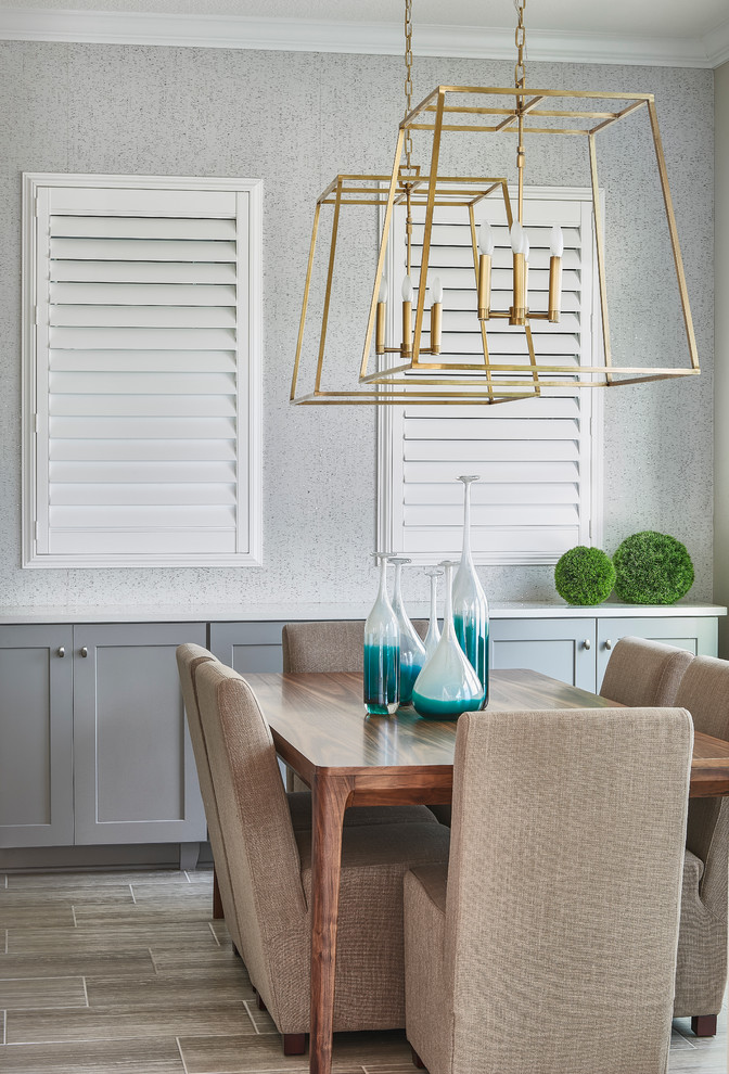 Mid-sized transitional porcelain tile enclosed dining room photo in Orlando with gray walls