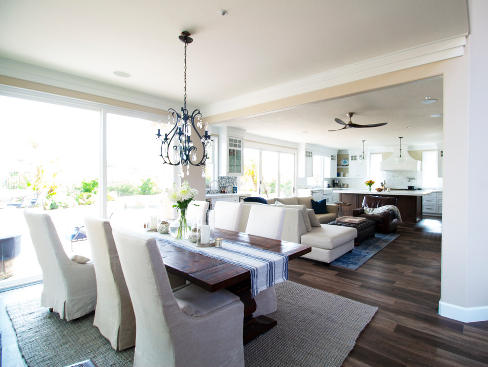 This is an example of a medium sized modern open plan dining room in Orange County with beige walls, dark hardwood flooring, no fireplace and brown floors.
