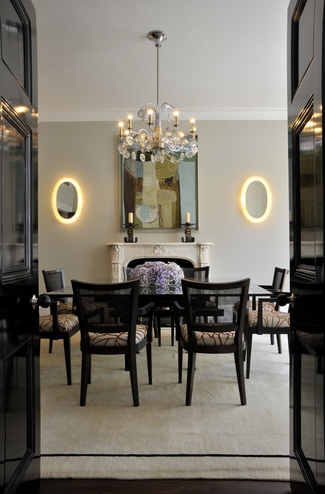 Traditional enclosed dining room in London with white walls, a standard fireplace and a stone fireplace surround.