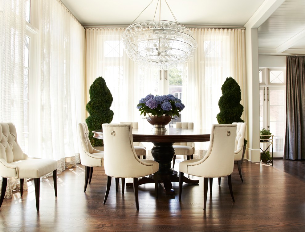 Design ideas for a coastal dining room in Miami with white walls, medium hardwood flooring and brown floors.