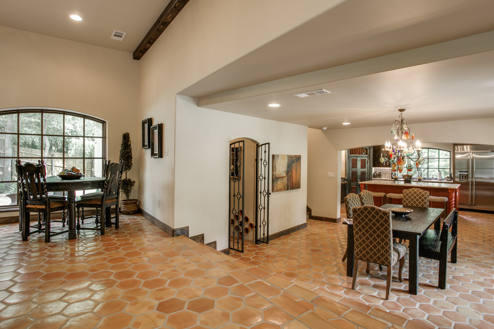 Design ideas for a large mediterranean open plan dining room in Dallas with beige walls and terracotta flooring.